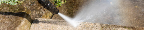 Pressure washer cleaning patio